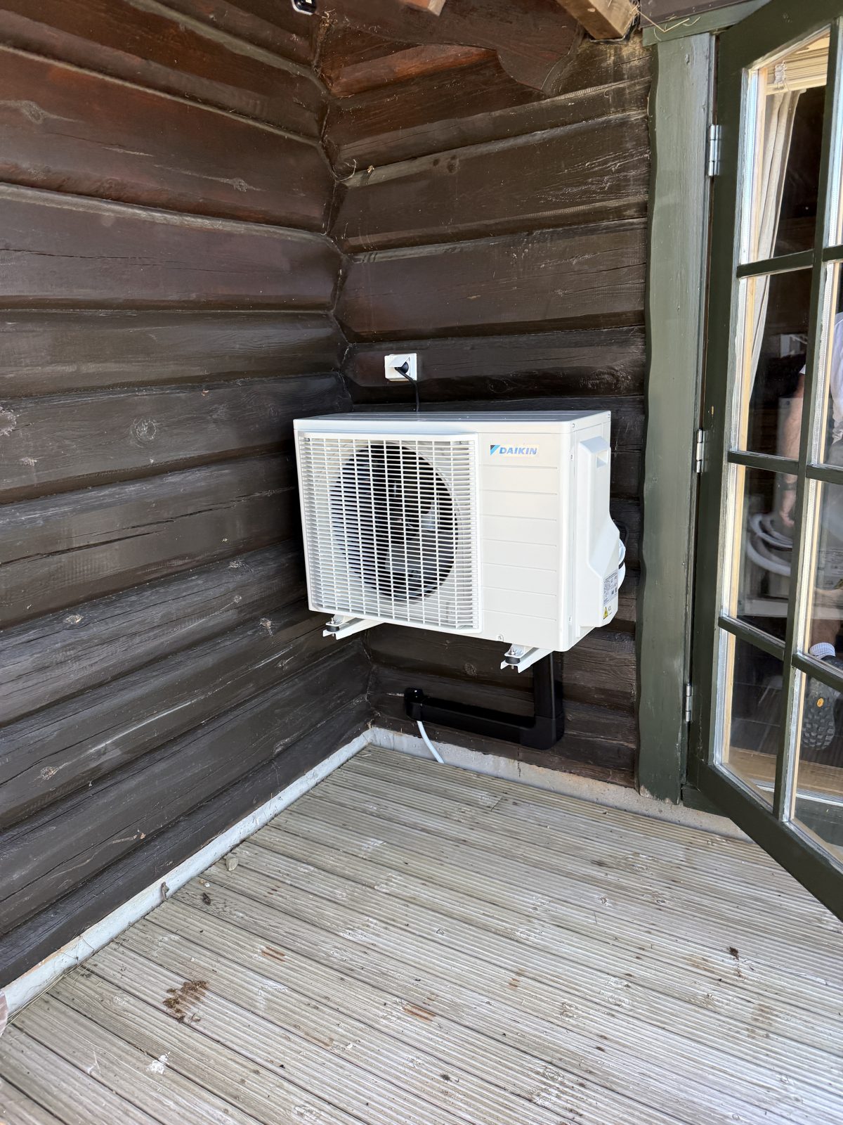 Utedel på mørk tømmervegg ved terrasse i Åseral